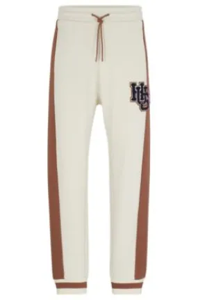 Cotton-terry tracksuit bottoms with varsity-inspired logo